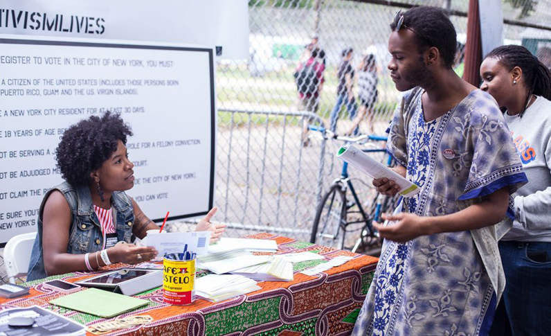 Milano Urban Policy alum Claudie Mabry helps register voters at Progressive Pupil's Activism Row. Photo by Richard Louissaint.