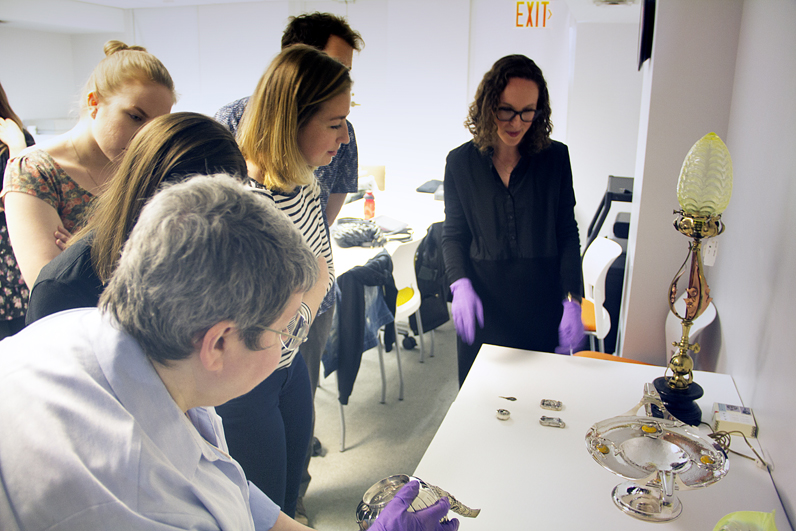 Students in the History of Design and Curatorial Studies program examine historical objects at the Cooper Hewitt, Smithsonian Design Museum.