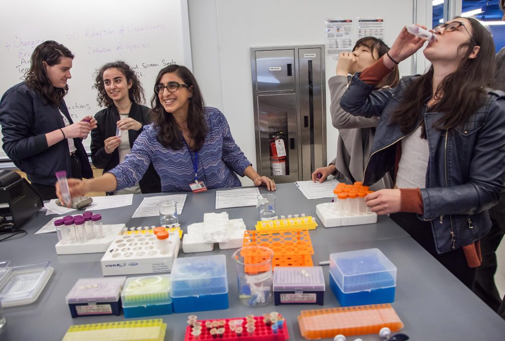 Katayoun Chamany, center, teaches students during the Interdisciplinary Science Labs open house at the University Center