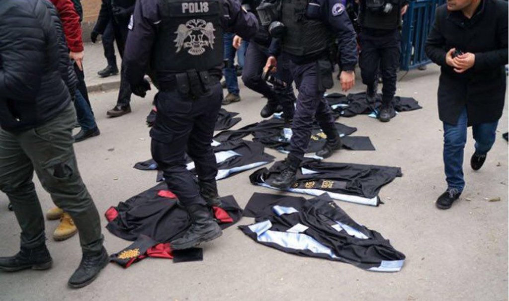 In Ankara, police trample academic regalia laid down in protest against the dismissal of academics from universities (Photo/Umit Bektas, Reuters).