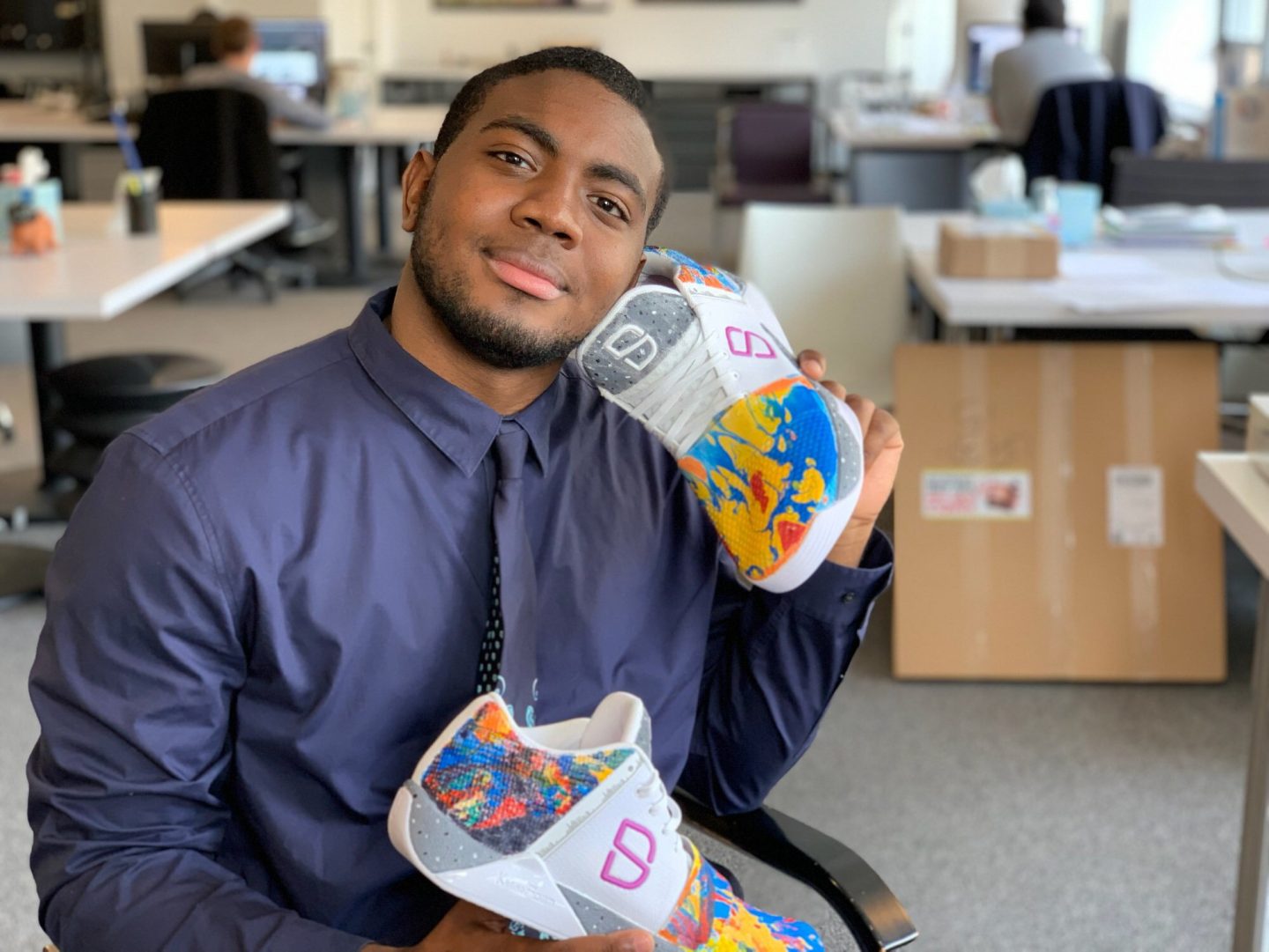 Jahkill Rashad displaying the sneaker he designed for Brooklyn Nets star, Spencer Dinwiddie. 