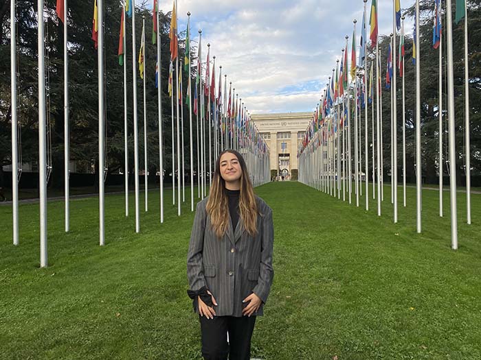 Gabriela Meschoulam standing in front of the United Nations Office in Geneva which is housed at the Palais des Nations