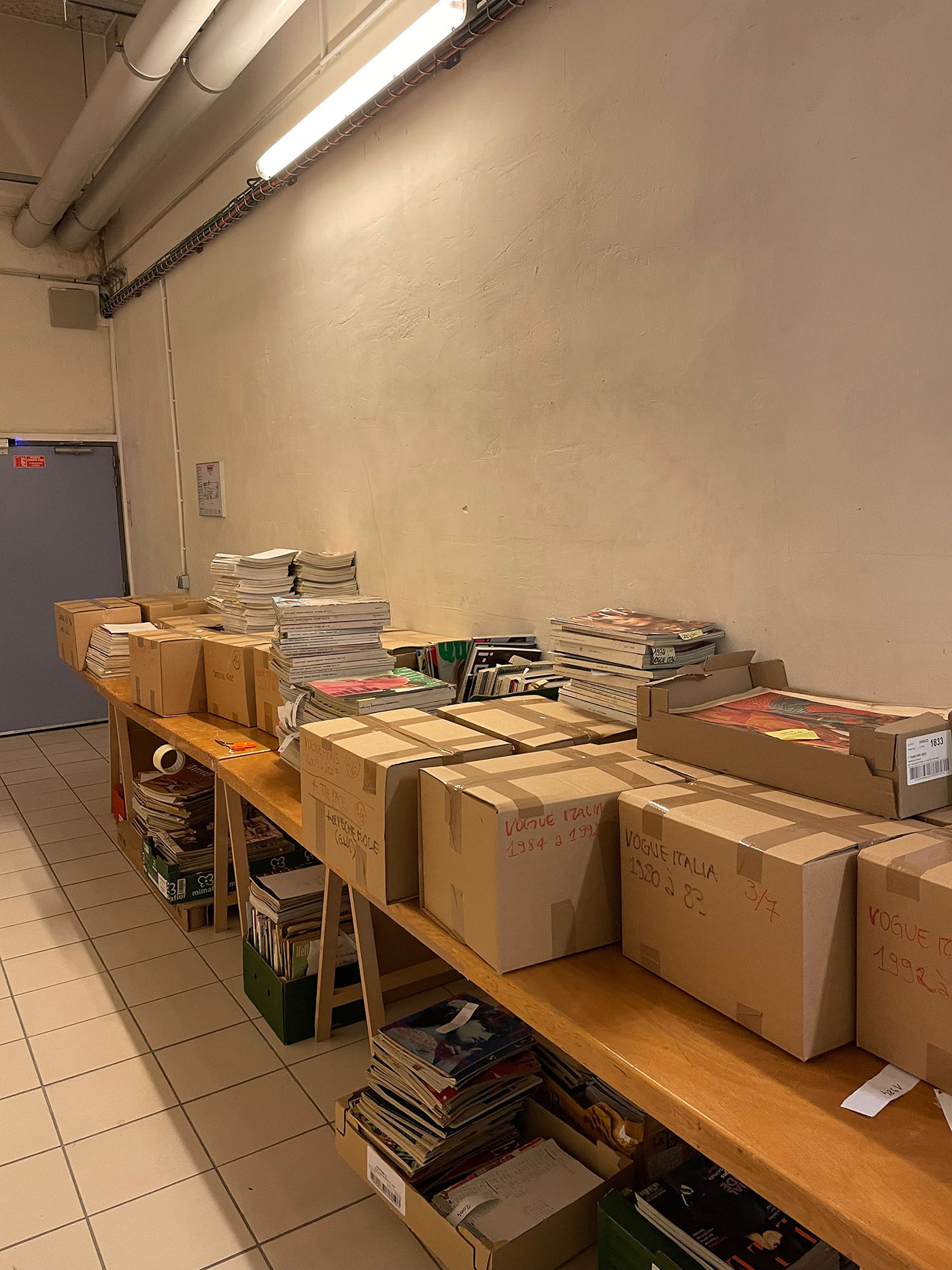 Boxes in the archives of Palais Galliera ready to be shipped to Parsons Paris